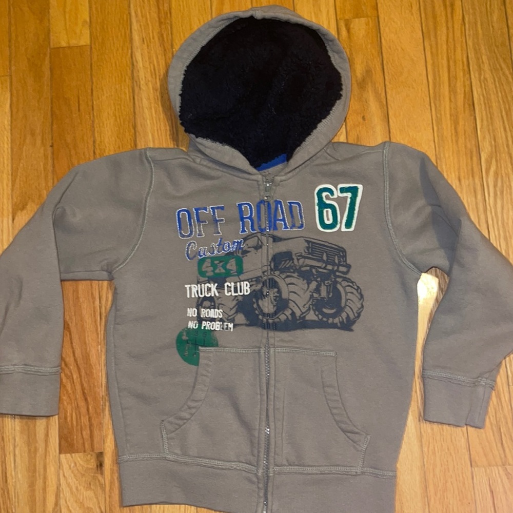 Gray zip up blue plush lined hoodie part with truck theme and #67 on the back.